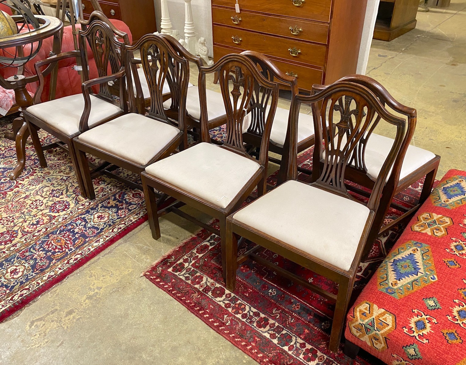 A set of seven George III style mahogany dining chairs, one with arms, together with a similar elbow chair